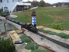 My Shay runs pass the lighthouse with a consist of my ET&WNC hoppers.