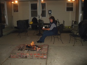 Operations extend into darkness on Saturday, but Jane, our dispatcher, does get a chance to warm up by the fire.