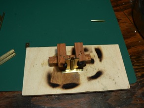 A homebuilt jig holds the pieces in place to be soldered. I use a mini-torch to apply heat - and burn the jig. 